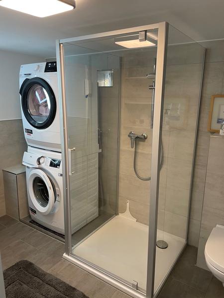 Shower and washing machine with dryer