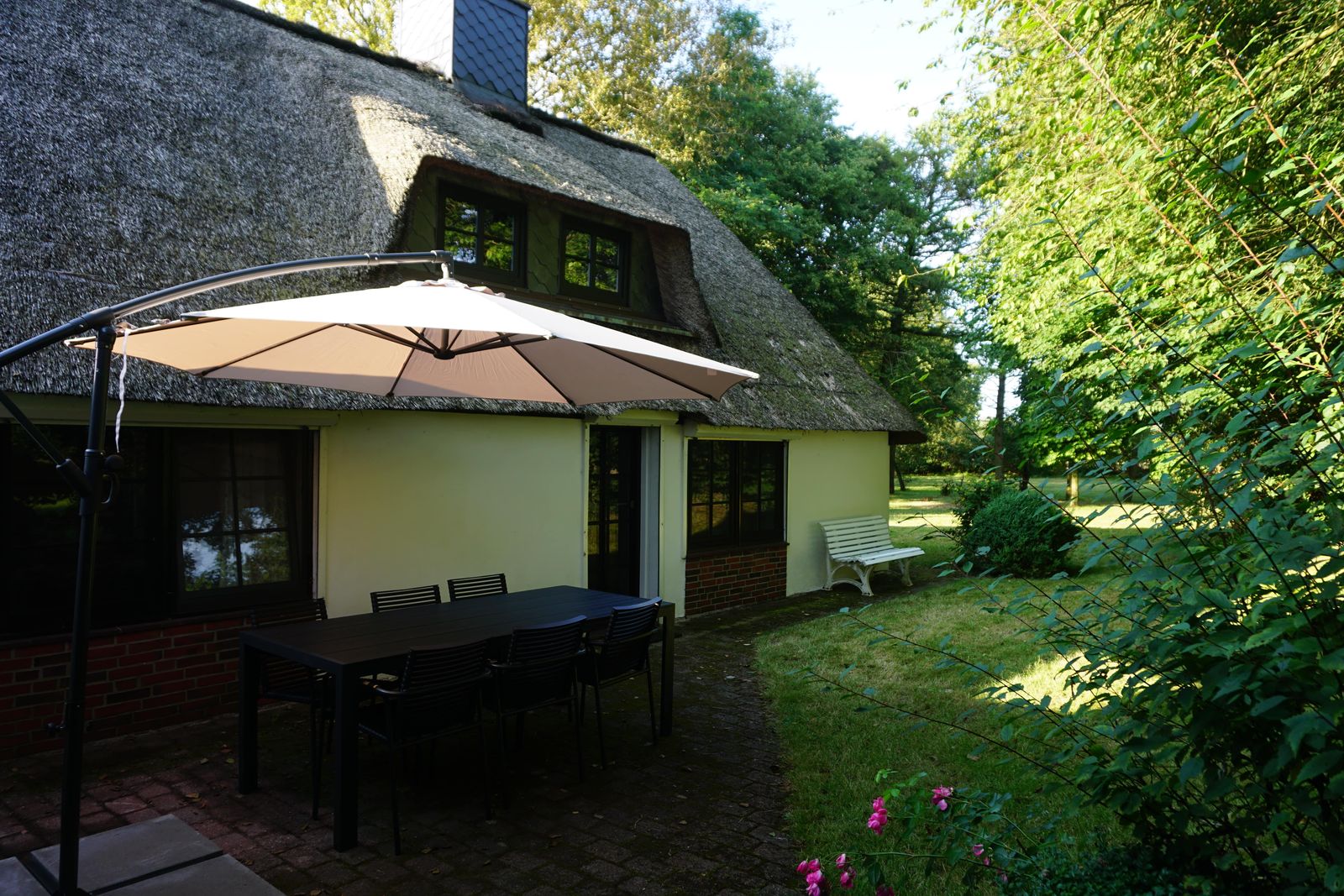 Terrace with garden furniture and parasol